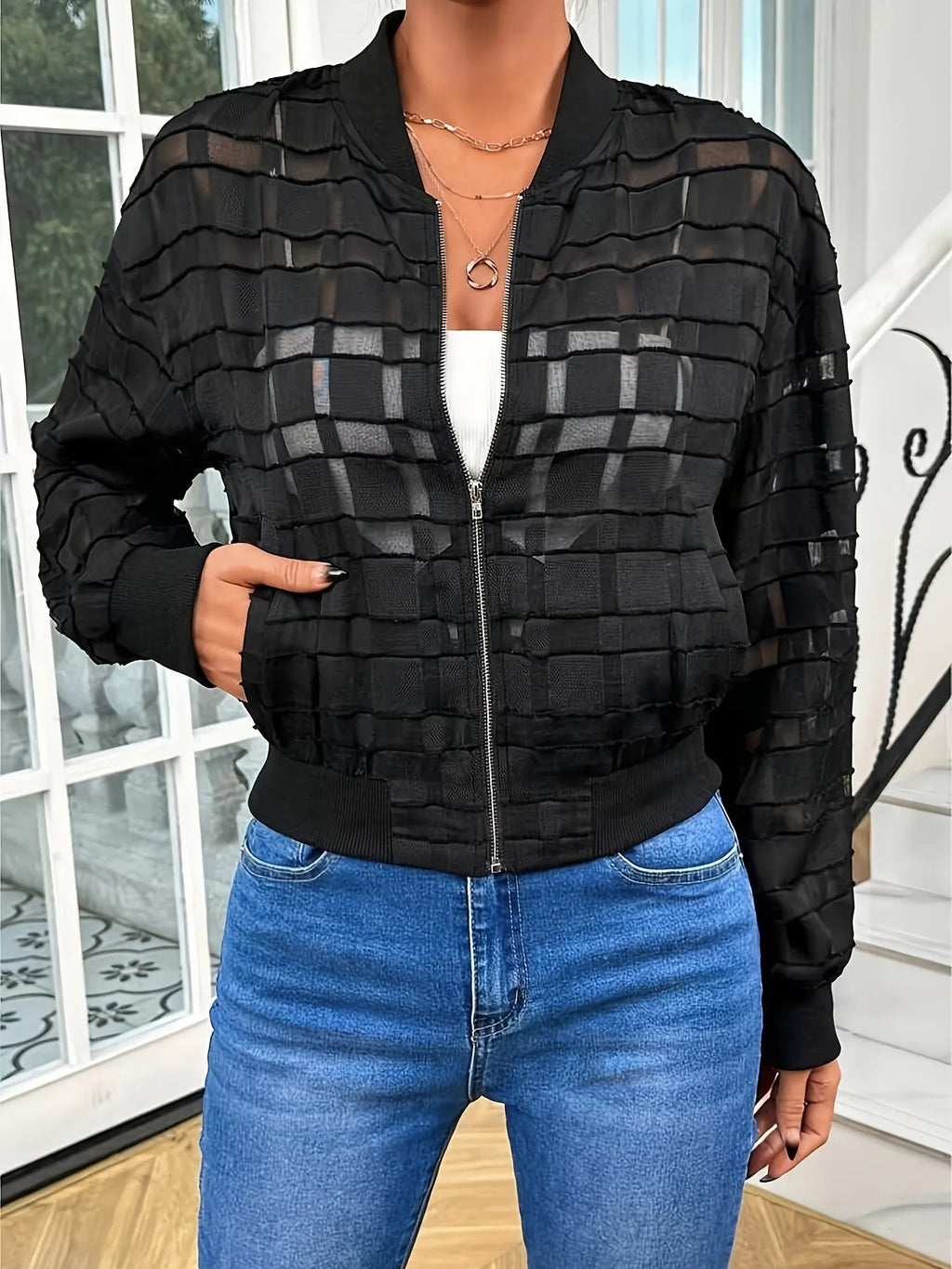 Black women's semi-transparent casual jacket with geometric pattern and front zipper.