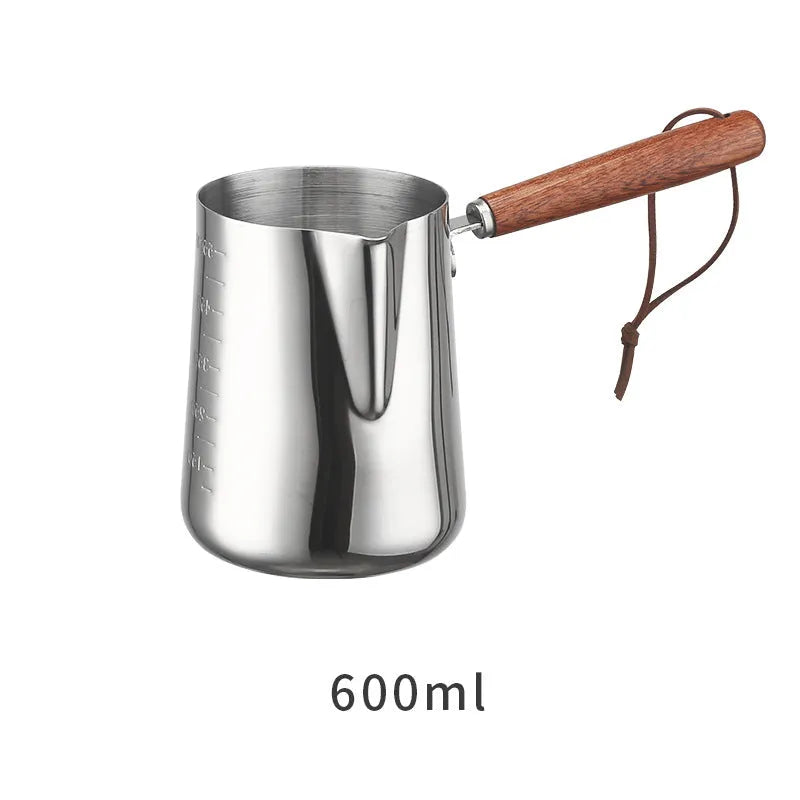 Stainless steel latte art milk cup with wooden handle and interior measuring scale
