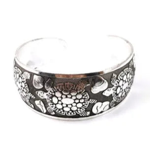 Carved open ethnic bracelet with Miao silver style design in alloy material showing elephant or turtle colour motifs