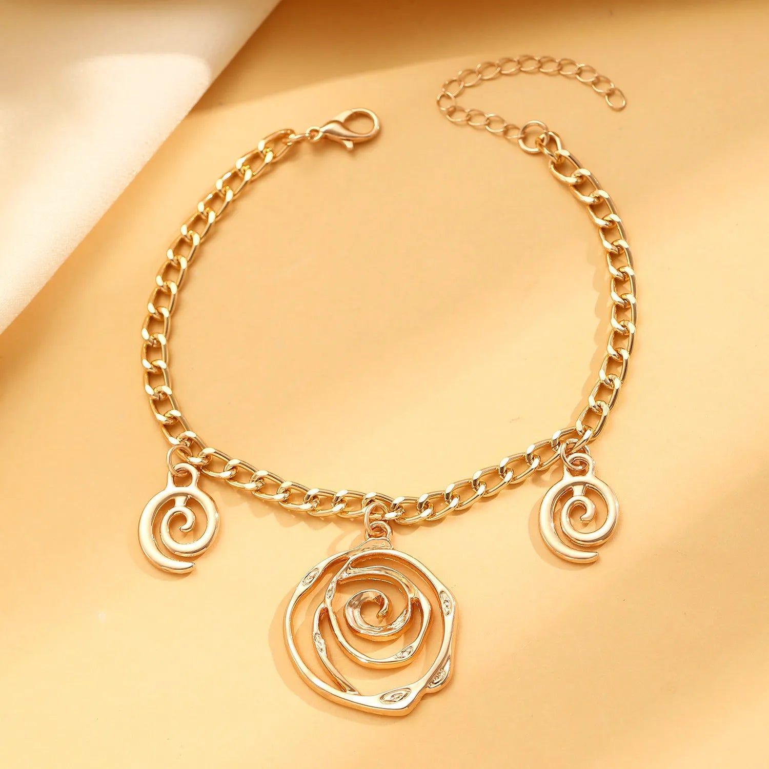 Spiral donut design jewellery set with necklace, bracelet and earrings in gold electroplated alloy