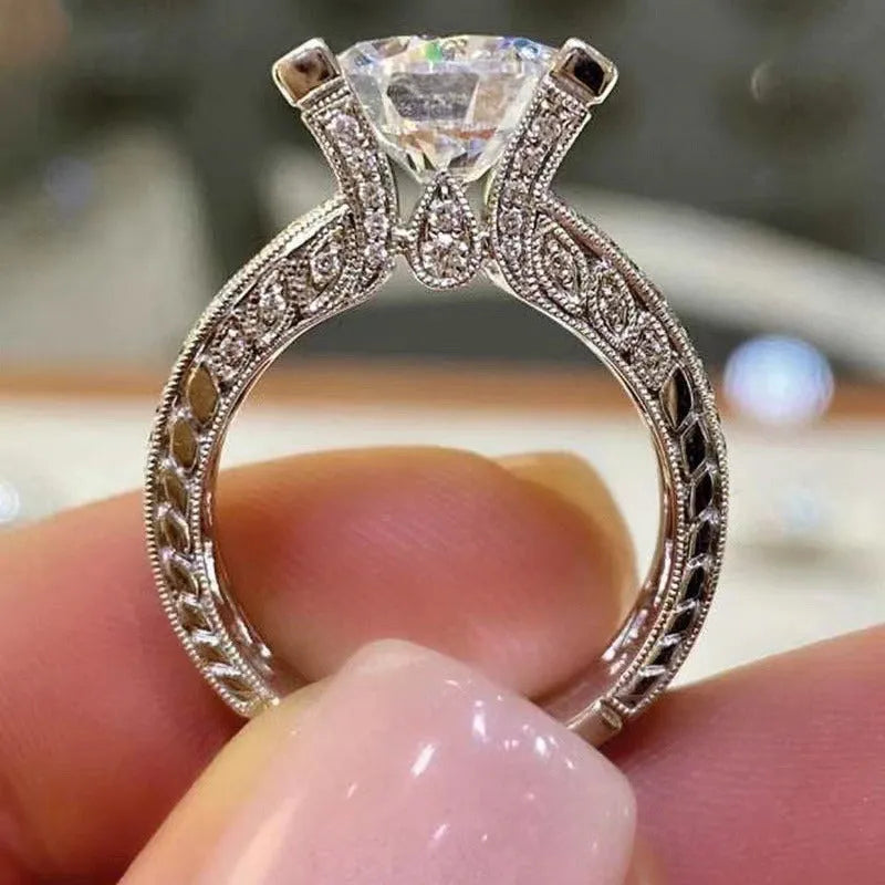A geometric silver-tone women's ring with round elements, shown in gold and white colour options.