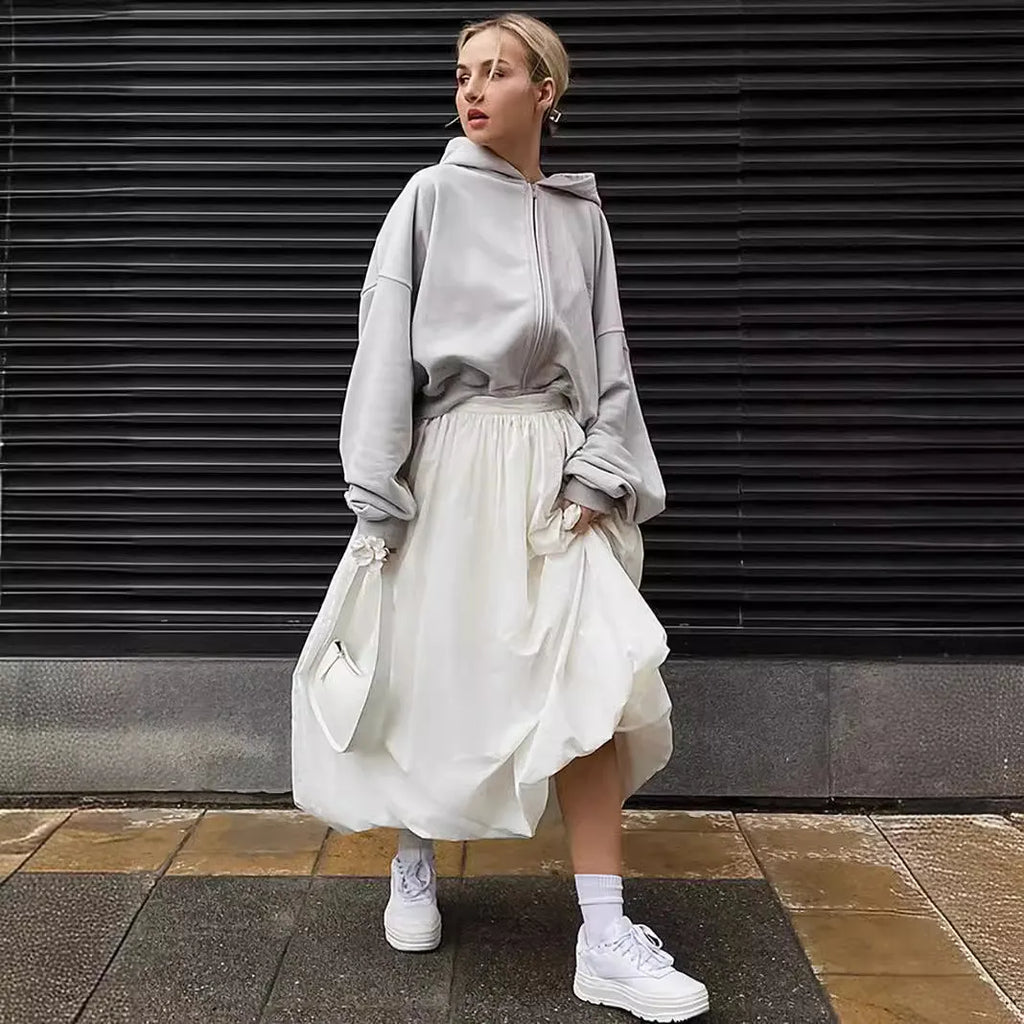 Women's solid colour cotton long skirt with elastic waistband in black or white.