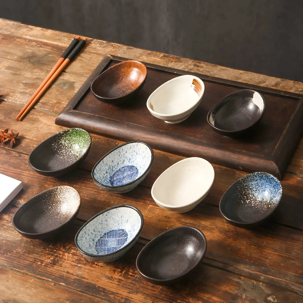 Oval-shaped Japanese ceramic sauce dipping bowl with an underglaze decorative pattern.