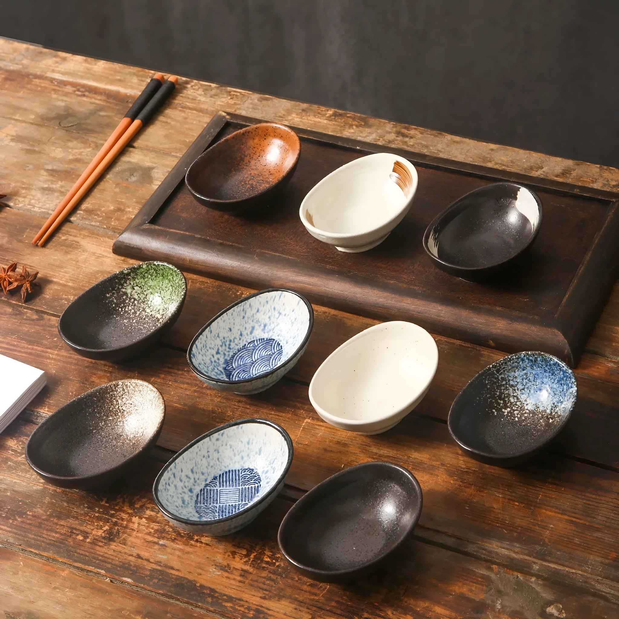Oval-shaped Japanese ceramic sauce dipping bowl with an underglaze decorative pattern.