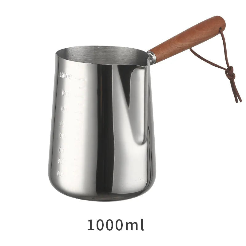 Stainless steel latte art milk cup with wooden handle and interior measuring scale