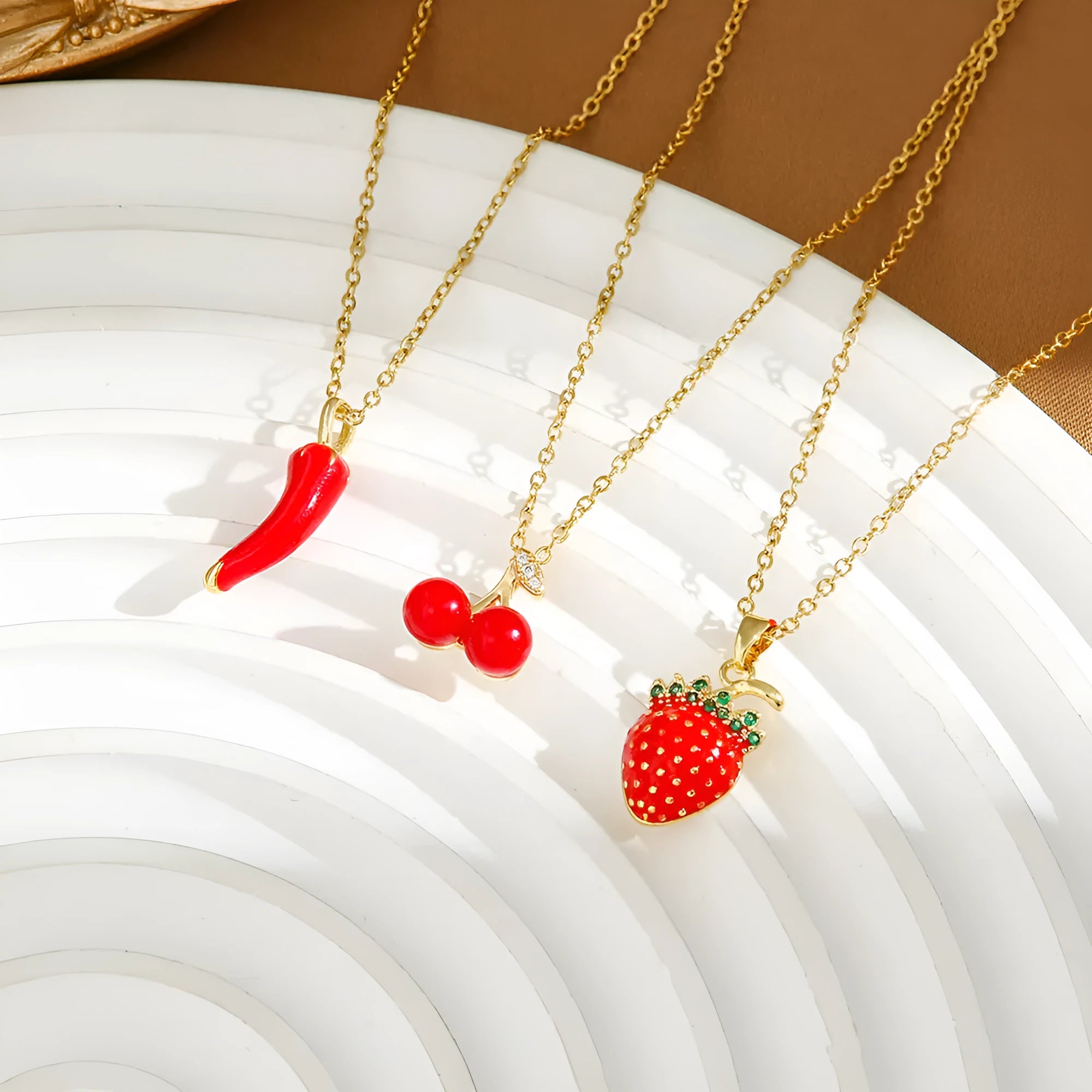 Golden indie necklace with detailed cherry, strawberry, and pepper pendant on a titanium steel O-ring chain.