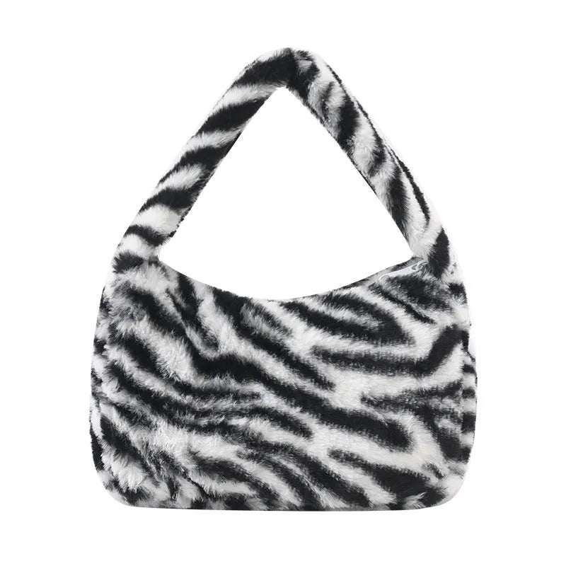 Plush retro shoulder bag in zebra print with single strap and polyester lining