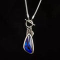 Long women's necklace with geometric alloy pendant on snake bones chain in plaid pattern