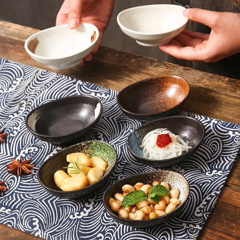 Oval-shaped Japanese ceramic sauce dipping bowl with an underglaze decorative pattern.