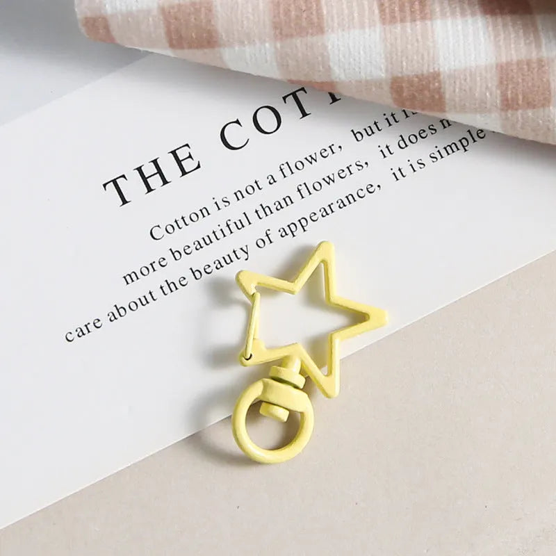 Metal five-pointed star snap button keychain with colour paint finish in alloy, small size, thirteen colour options including beige and sapphire blue