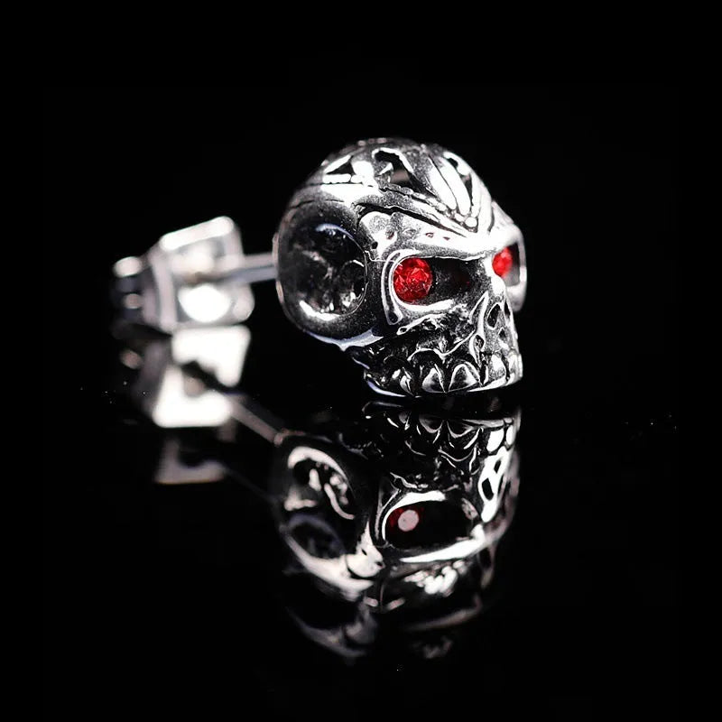 Retro skull stud earrings with ghost head design and red eye detail on alloy background