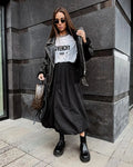 Women's solid colour cotton long skirt with elastic waistband in black or white.