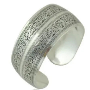 Carved open ethnic bracelet with Miao silver style design in alloy material showing elephant or turtle colour motifs