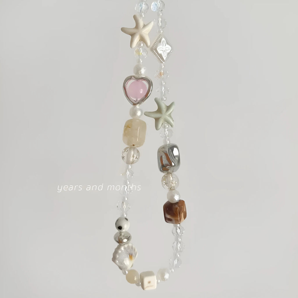 Bohemian style mobile phone charm with beach camera design in island sweetheart colours and alloy construction