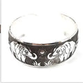 Carved open ethnic bracelet with Miao silver style design in alloy material showing elephant or turtle colour motifs