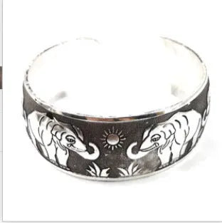 Carved open ethnic bracelet with Miao silver style design in alloy material showing elephant or turtle colour motifs