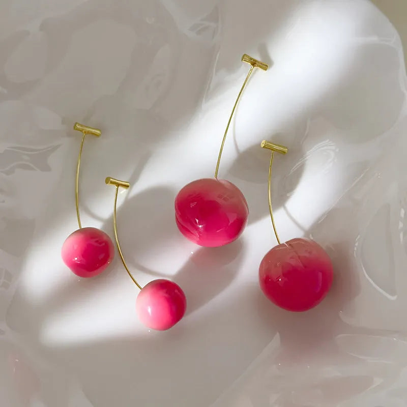 A pair of lightweight acrylic earrings shaped like peaches, shown in small and large size options.