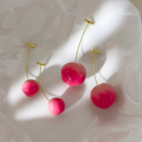 A pair of lightweight acrylic earrings shaped like peaches, shown in small and large size options.