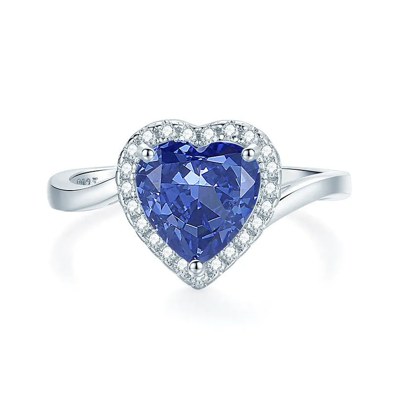 Heart-shaped sterling silver ring with a faceted colour zircon stone on a white background.