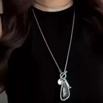 Long women's necklace with geometric alloy pendant on snake bones chain in plaid pattern