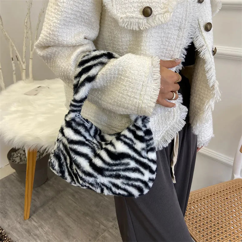 Plush retro shoulder bag in zebra print with single strap and polyester lining