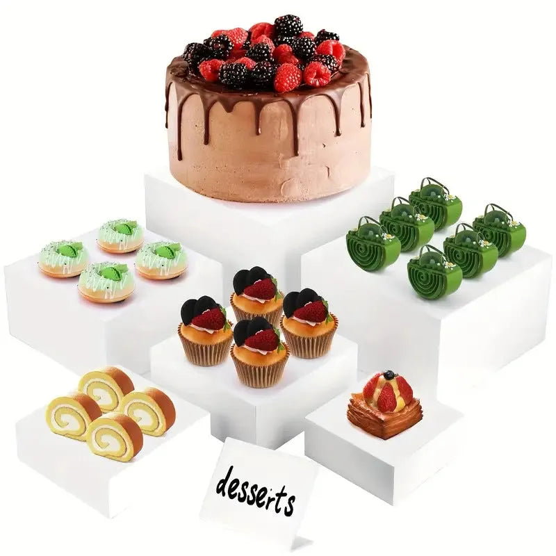 White plastic cube dessert display stand set of six pieces arranged on a table.