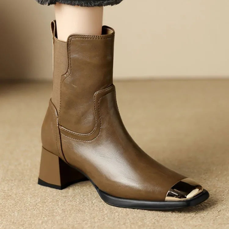Brown cowhide leather women's Martin boots with a high heel and side zipper detail.