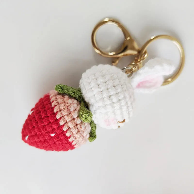 Hand-woven white rabbit strawberry pendant keychain made from four-strand doll wire.