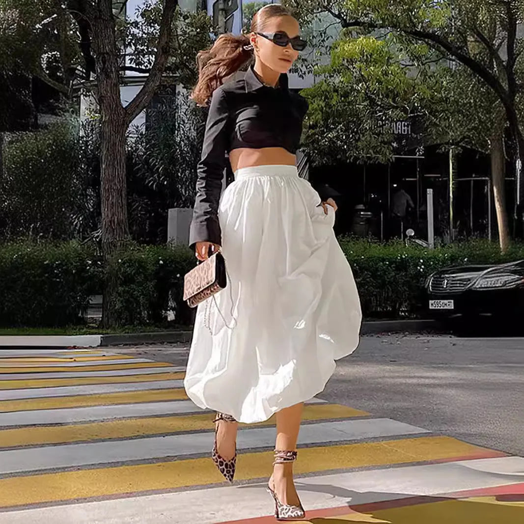 Women's solid colour cotton long skirt with elastic waistband in black or white.