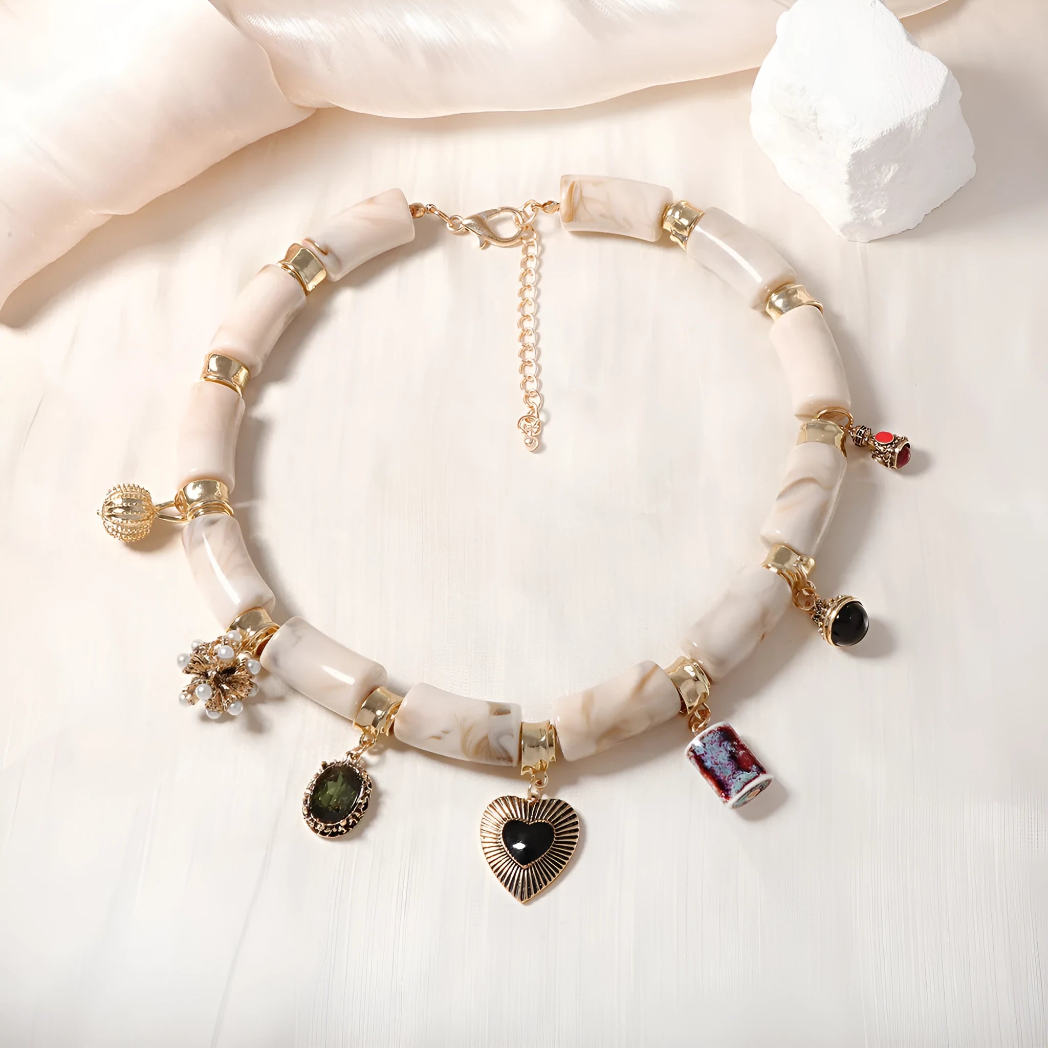 Heart-shaped resin and plastic pendant necklace with an electroplated finish for women.