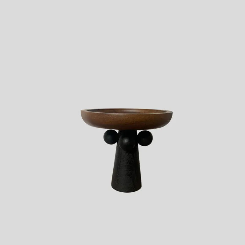 High-legged round wooden tray in a modern Nordic style for candle and decor display.
