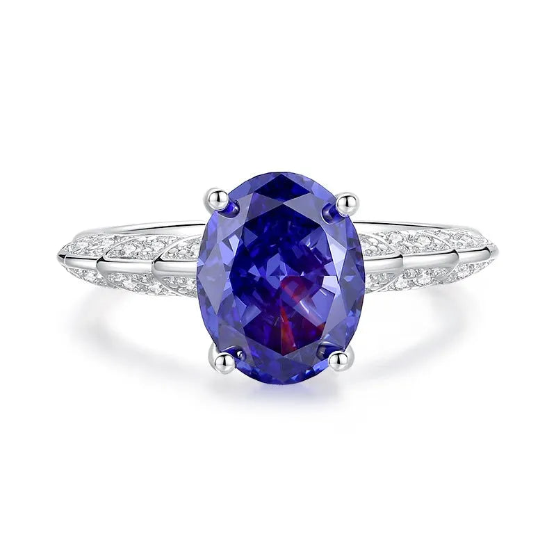 Heart-shaped sterling silver ring with a faceted colour zircon stone on a white background.