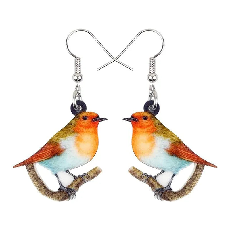 Acrylic clip-on earrings with a blue titmouse bird and geometric snake design.