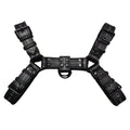 Black leather chest muscle bondage strap with metal buckle and rivets laid flat.