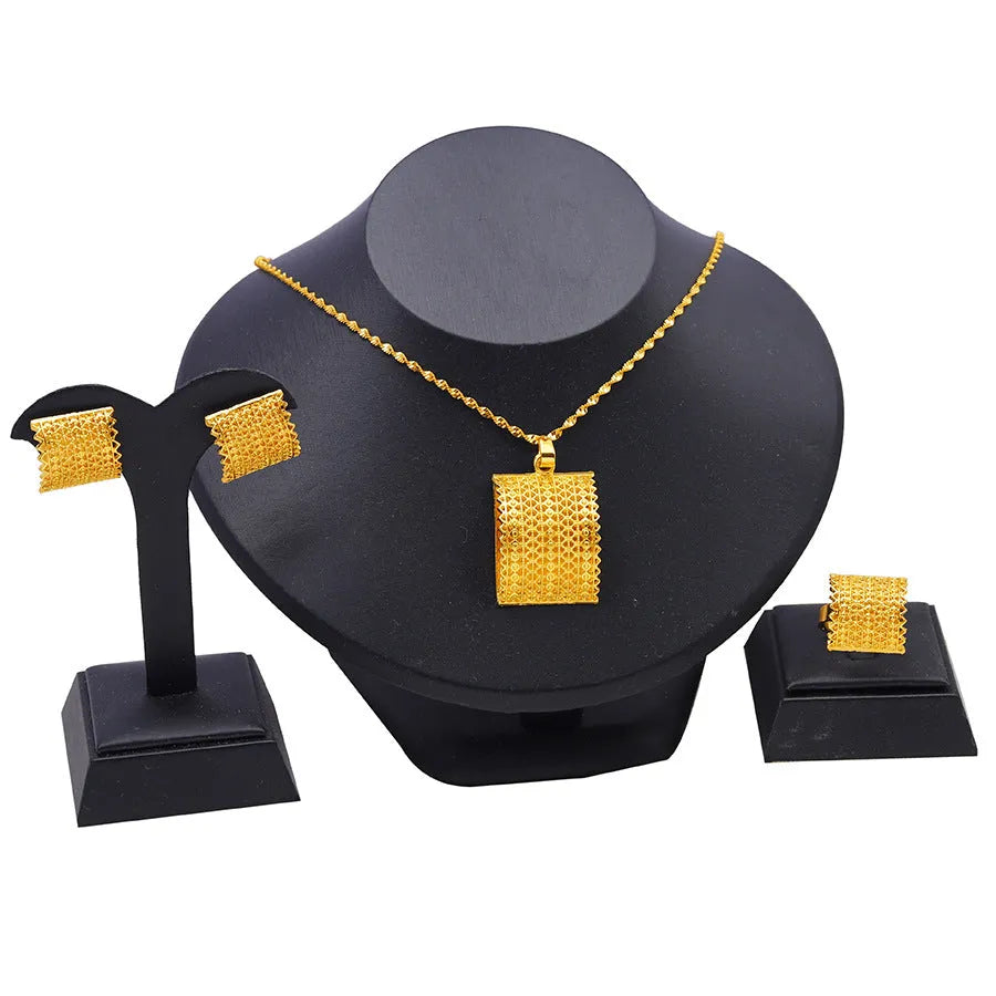 Golden copper bridal jewellery set featuring a necklace, pair of earrings, and a ring.