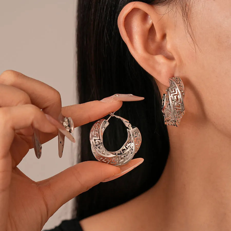 Twisted geometric hollow stud earrings in silver or gold colour with round shapes