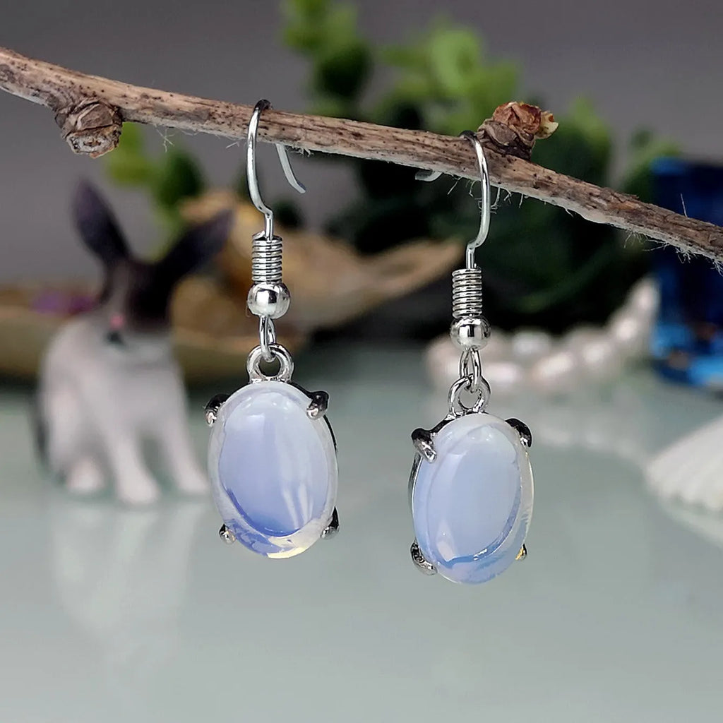 Moonlight white opal drop earrings with elliptical cross design on alloy electroplated setting