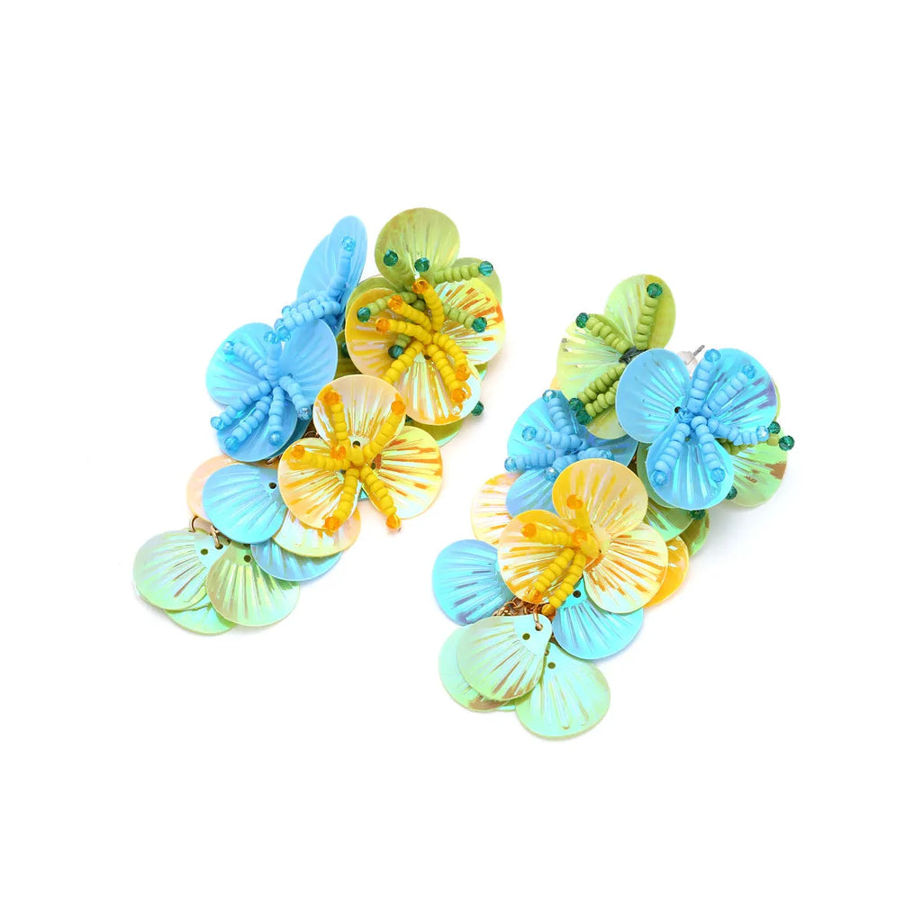 A pair of handmade colourful string bead flower and leaf earrings in an exaggerated design.