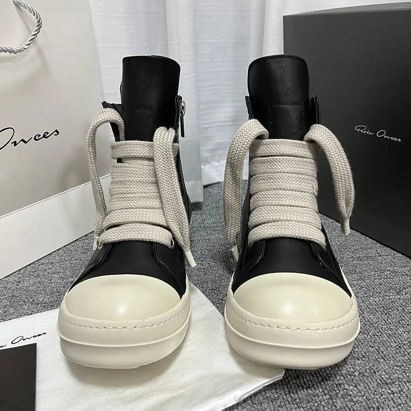 Black high-top leather sneakers with side zipper and round toe on a platform sole.