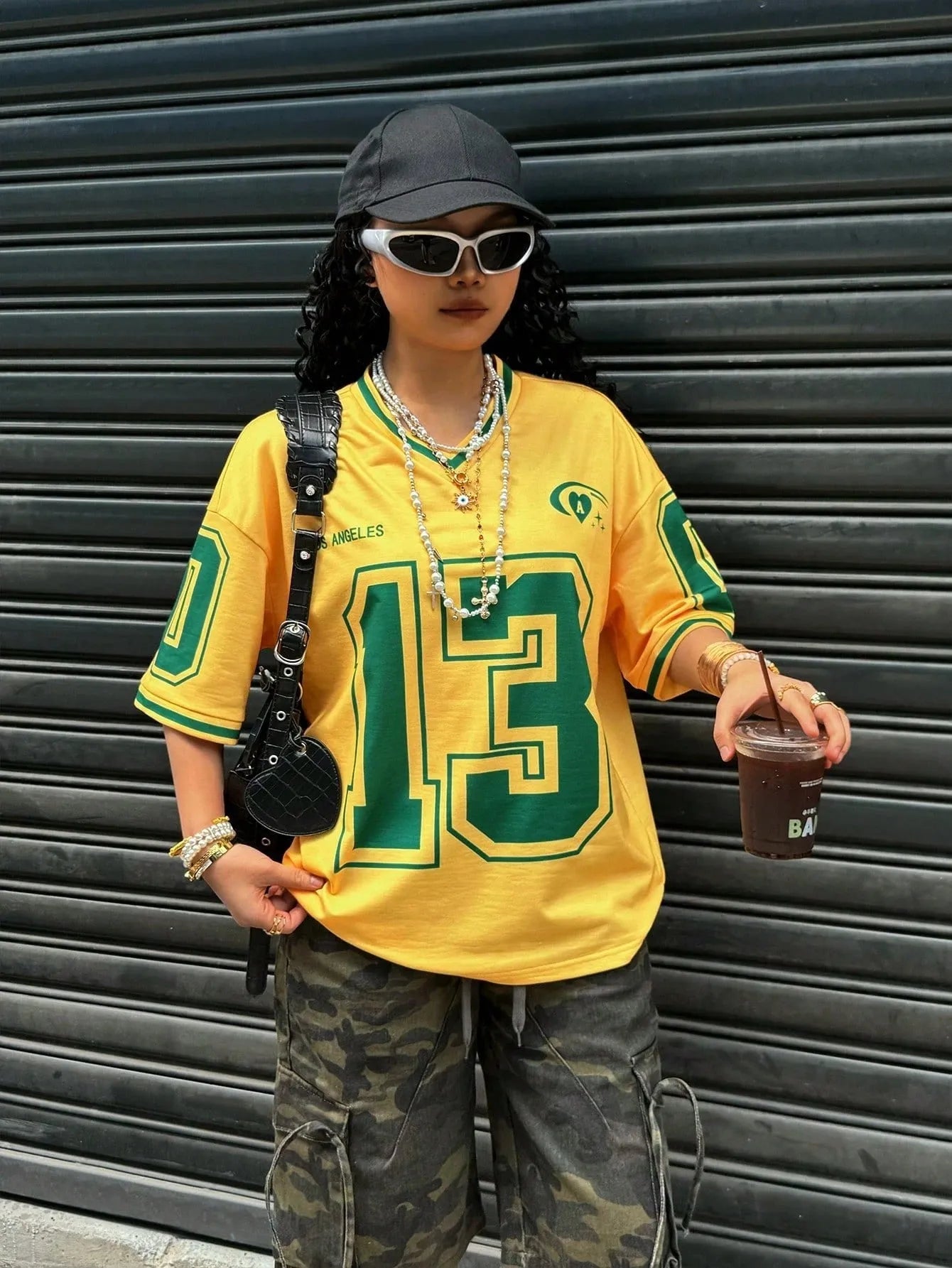 Women's loose fit V-neck short sleeve t-shirt with raised 3D letter print design on the front.
