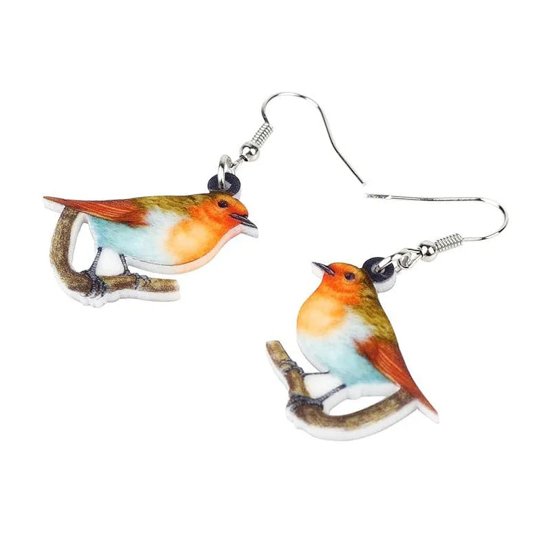 Acrylic clip-on earrings with a blue titmouse bird and geometric snake design.