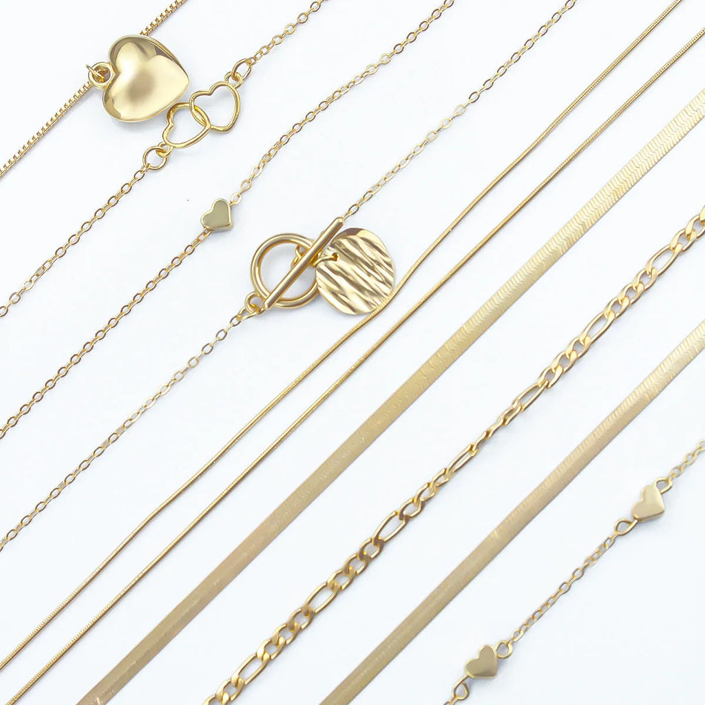 Women's gold necklace set with 10 pendant pieces on adjustable snake bone chain