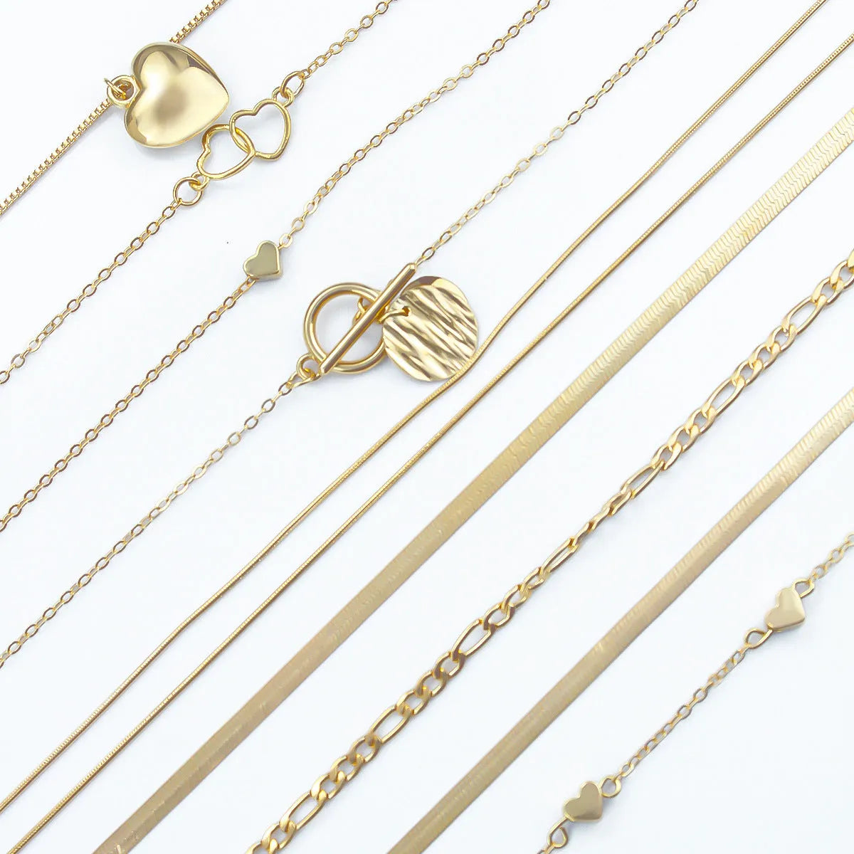 Women's gold necklace set with 10 pendant pieces on adjustable snake bone chain