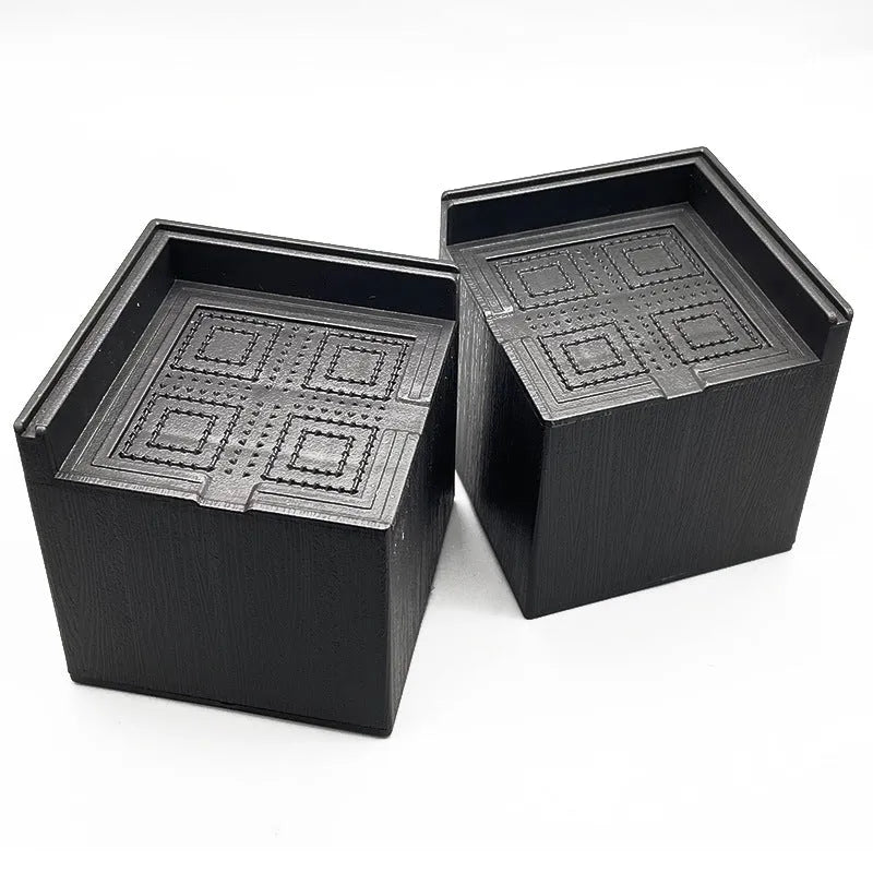 Four black plastic furniture height adjustment mats for bed and sofa legs
