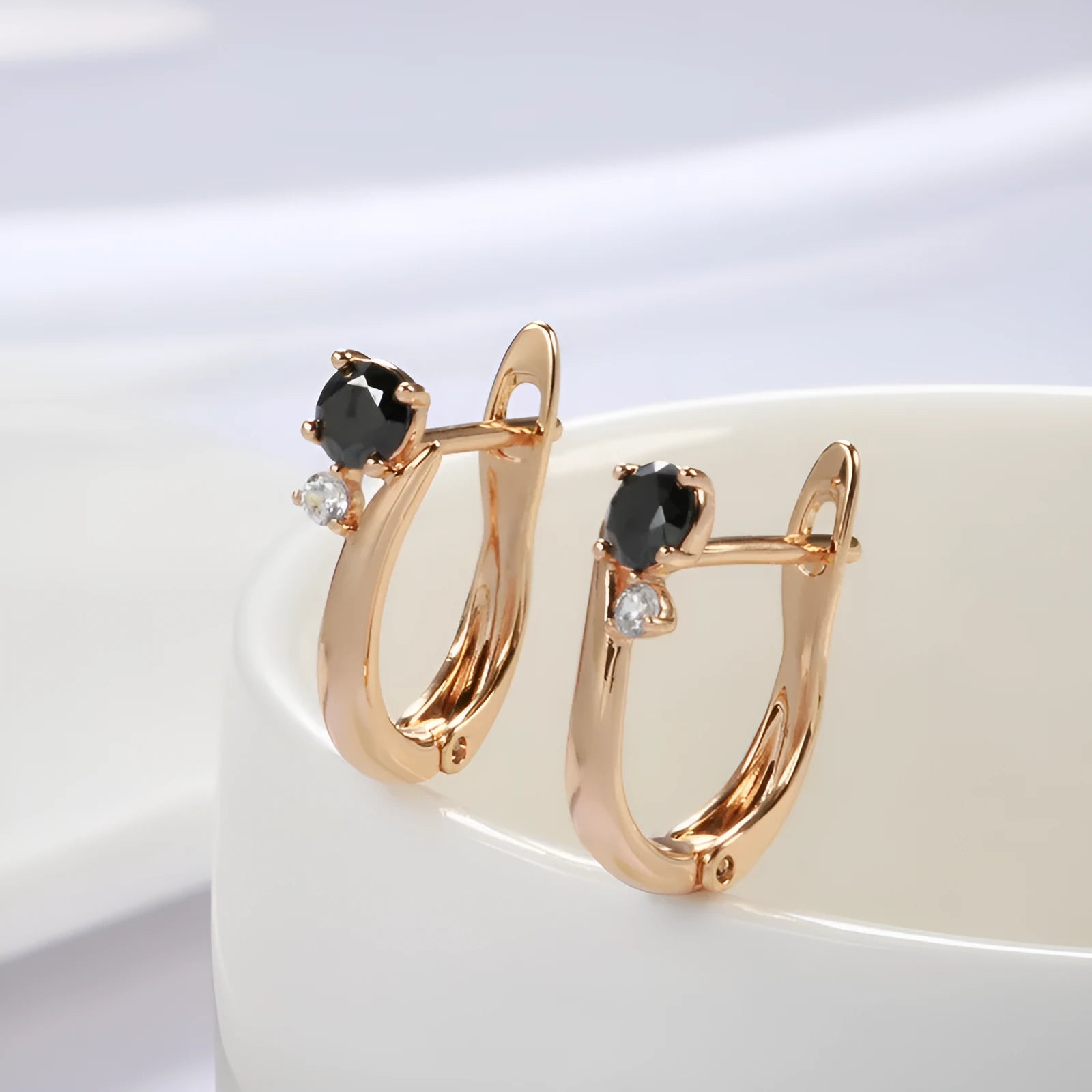 Gold geometric drop shape earrings with black agate stones, retro cold wind style.