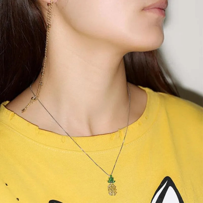 Silver geometric pineapple diamond necklace on white background