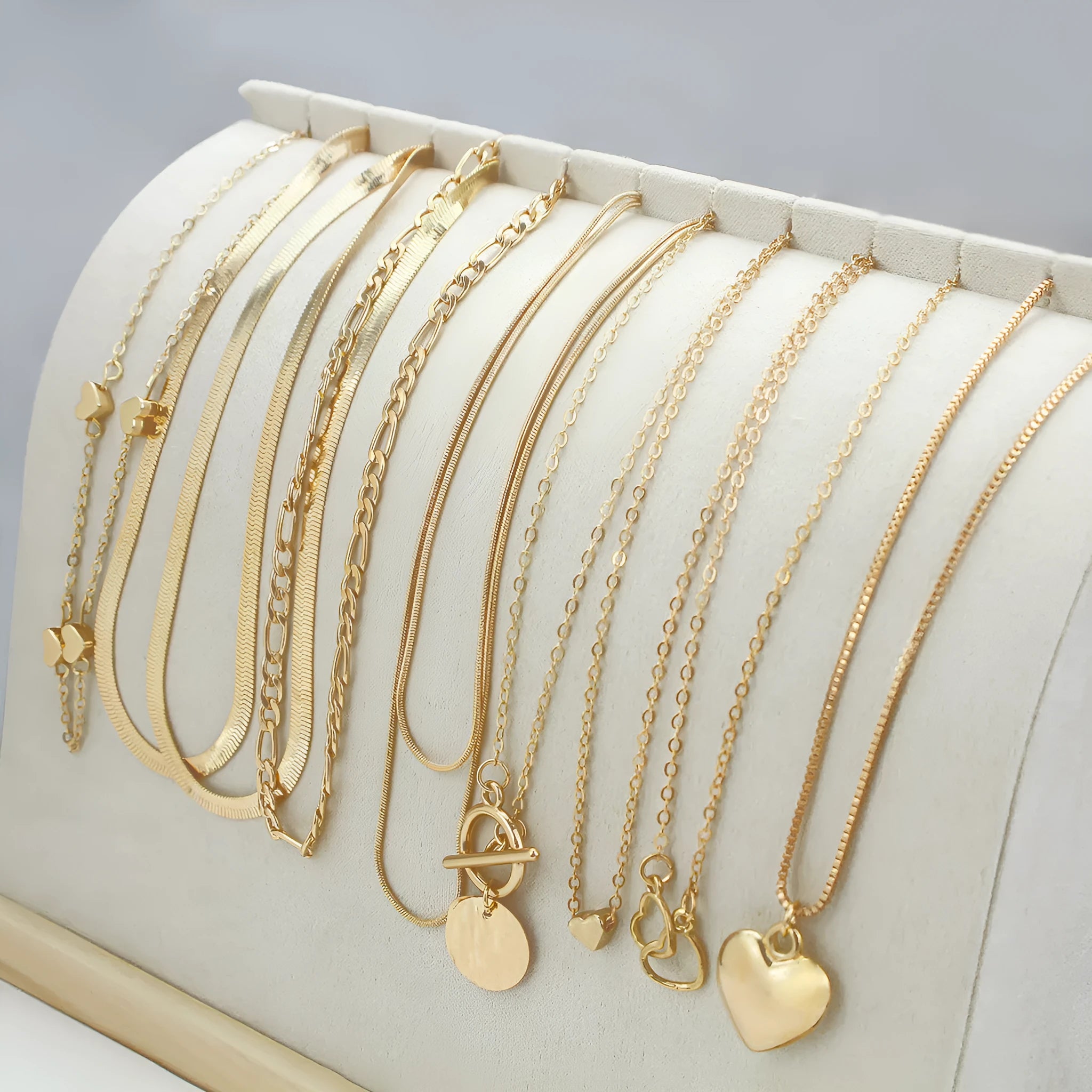 Women's gold necklace set with 10 pendant pieces on adjustable snake bone chain
