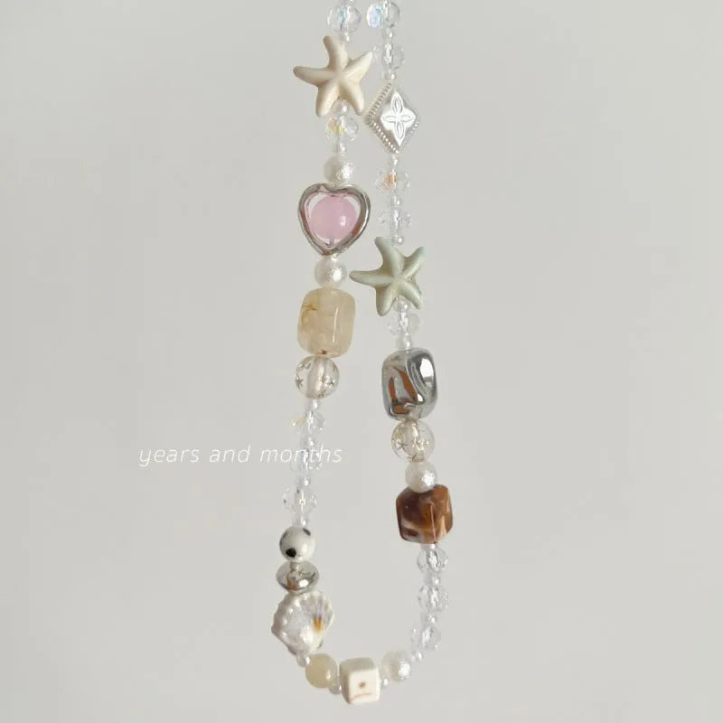 Bohemian style mobile phone charm with beach camera design in island sweetheart colours and alloy construction