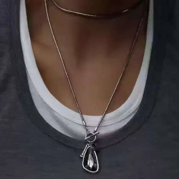 Long women's necklace with geometric alloy pendant on snake bones chain in plaid pattern