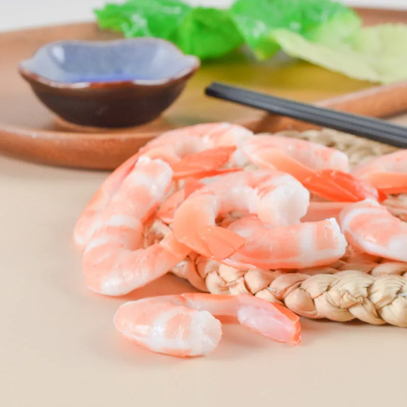 White PVC shrimp simulation keychain with metal door buckle, shown from the side to highlight its 1.5cm thickness.